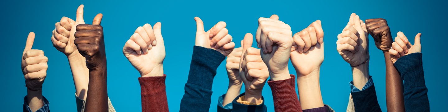 Photo of lots of hands making a thumbs up sign.